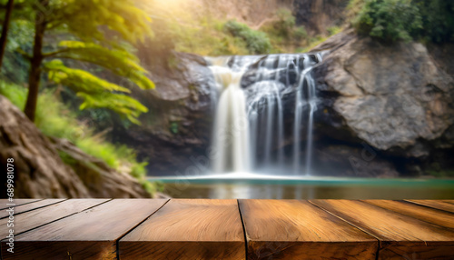 Empty wooden table on blurred background waterfall in the jungle