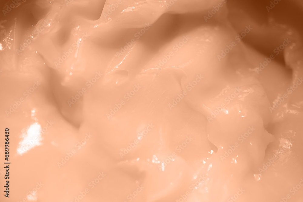 Fototapeta premium Beauty cream texture. Creamy skincare product closeup. Color peach fuzz.