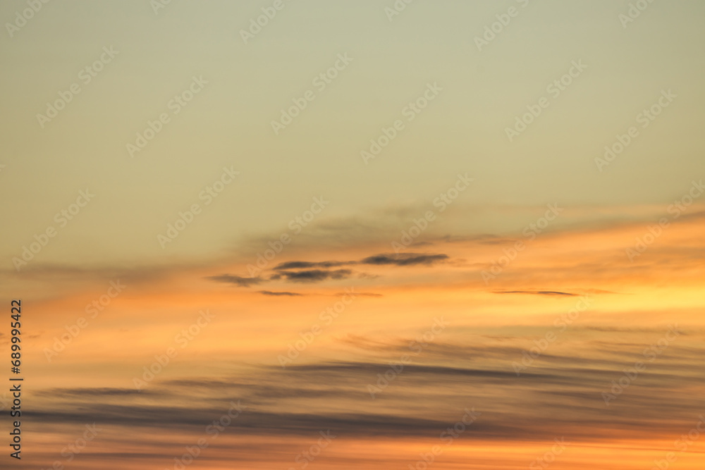 A beautiful sky tinted by the sun leaving vibrant shades of gold, pink, blue and multicolored. Clouds in the twilight evening and morning sky. Image of a cloudy sky in the evening and during the day