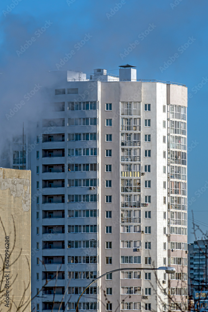 A fragment of the facade of a multi-storey residential building on a winter day
