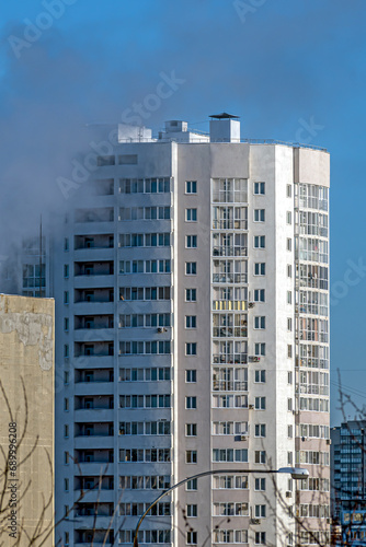 A fragment of the facade of a multi-storey residential building on a winter day