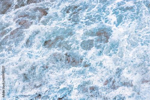 Wave splashing close-up. Crystal clear sea water, in the ocean in San Francisco Bay, blue water, pastel colors.