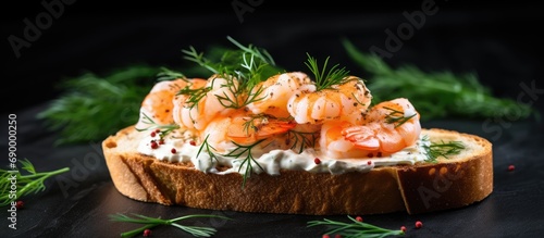 Toasted bread topped with cream cheese and cooked shrimp