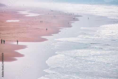 Photography Top view of beautiful landscape in fog, people walking along Ocean Beach, San Francisco