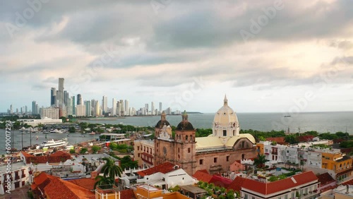 Wallpaper Mural Aerial drone view of the old town of Cartagena de Indias in Colombia.The new cityscape in the distance. Camera moving forward toward the scenic old  church San Pedro Claver. Torontodigital.ca