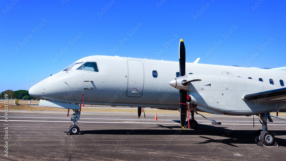 Private exclusive small jet aircraft parked on tarmac of airport, Blue sky area, Private jet on the runway. Private exclusive small jet aircraft parked on tarmac of airport, Blue sky area, Private jet on the runway.