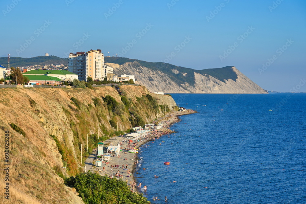 High bank with promenade and beach in Anapa city at sunset