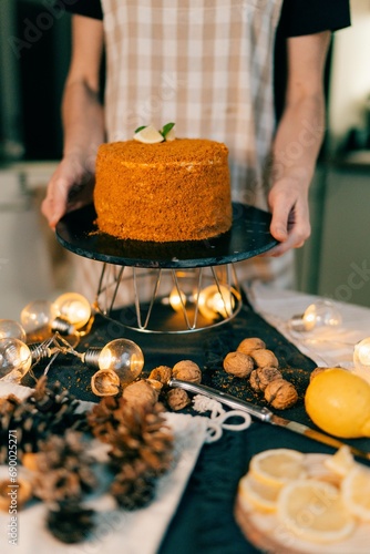 Photography Woman baking Christmas Pavlova cake and New Year's honey cake