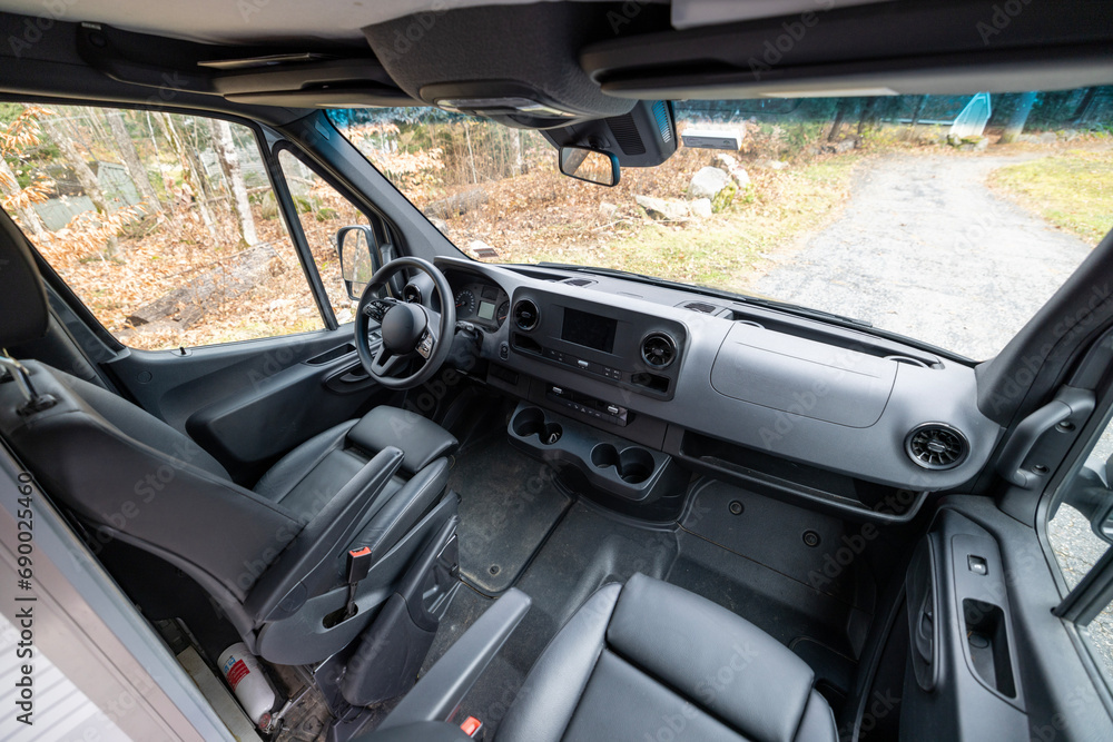 front seat interior of a vehicle on a country lane