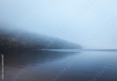 Shoreline disappears into the mist and fog, Donnell Pond, Maine