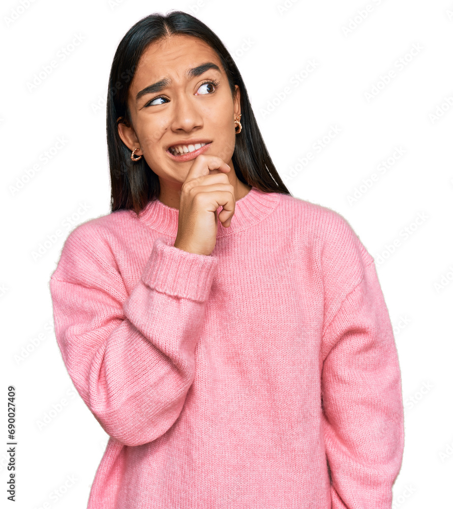 Young asian woman wearing casual winter sweater thinking worried about a question, concerned and nervous with hand on chin Young asian woman wearing casual winter sweater thinking worried about a question, concerned and nervous with hand on chin