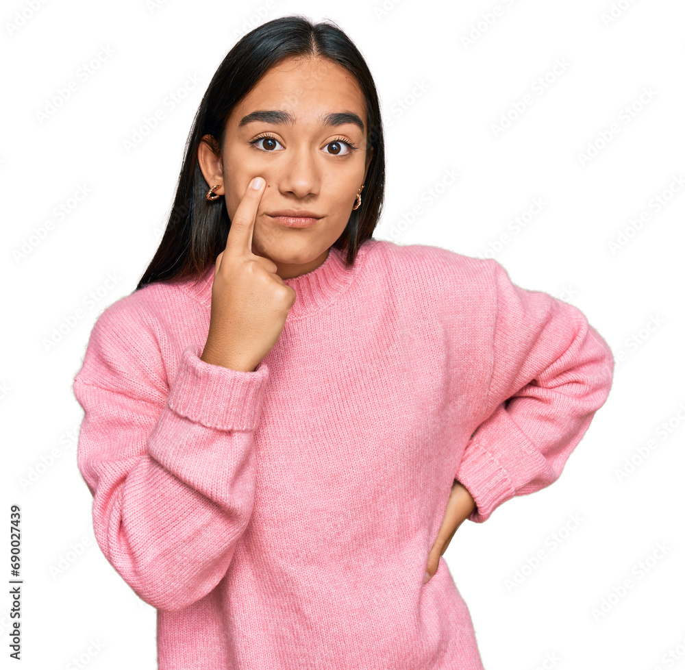 Young asian woman wearing casual winter sweater pointing to the eye watching you gesture, suspicious expression Young asian woman wearing casual winter sweater pointing to the eye watching you gesture, suspicious expression