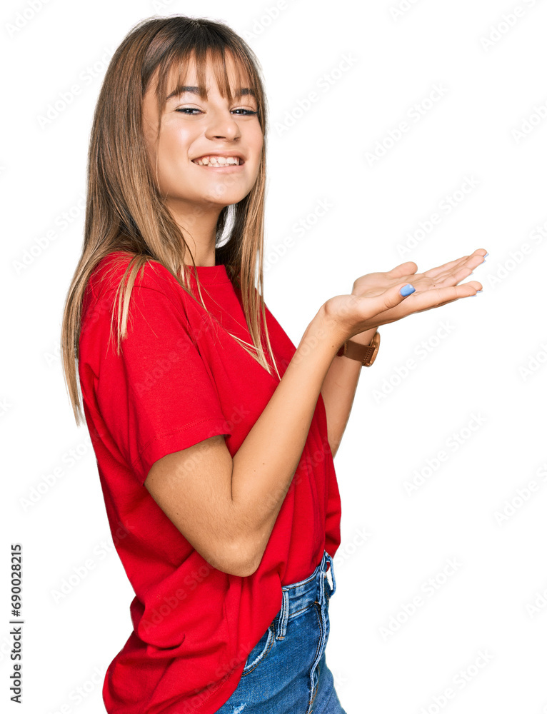 Teenager caucasian girl wearing casual red t shirt pointing aside with hands open palms showing copy space, presenting advertisement smiling excited happy Teenager caucasian girl wearing casual red t shirt pointing aside with hands open palms showing copy space, presenting advertisement smiling excited happy