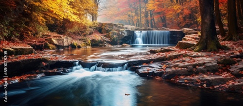 Waterfall in the autumn forest river.