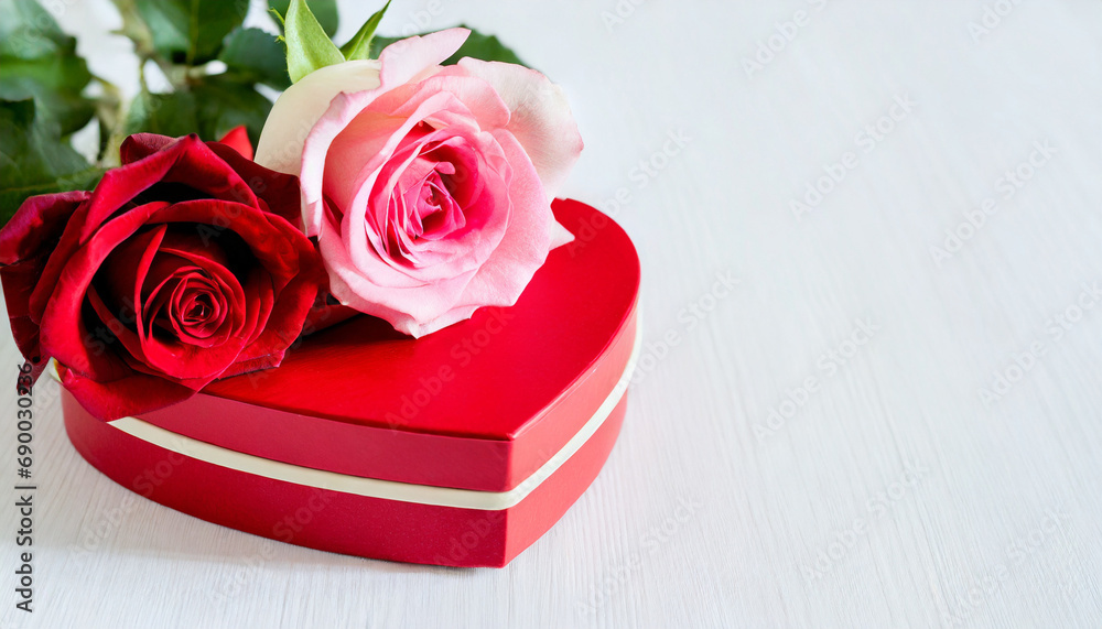 Fototapeta premium Heart shaped gift box with red and pink roses on white background - Valentine's Day