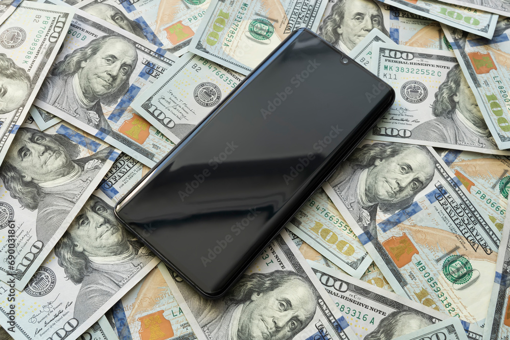 a blank screen on a smartphone with money. smartphone screen on US dollar banknotes background for design purpose a blank screen on a smartphone with money. smartphone screen on US dollar banknotes background for design purpose