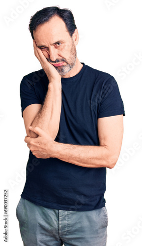 Middle age handsome man wearing casual t-shirt thinking looking tired and bored with depression problems with crossed arms.