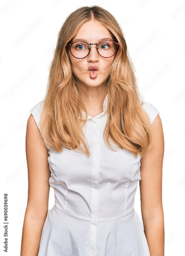 Beautiful young caucasian girl wearing casual clothes and glasses making fish face with lips, crazy and comical gesture. funny expression.