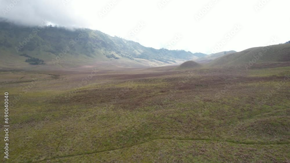 Aerial view of huge savannas and mist-covered mountain ranges Aerial view of huge savannas and mist-covered mountain ranges