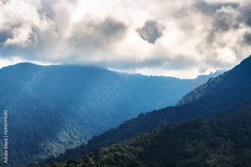 travel to Georgia - rays of sun break through gray clouds on mountain tops in outskirts of Batumi city on autumn day © vvoe