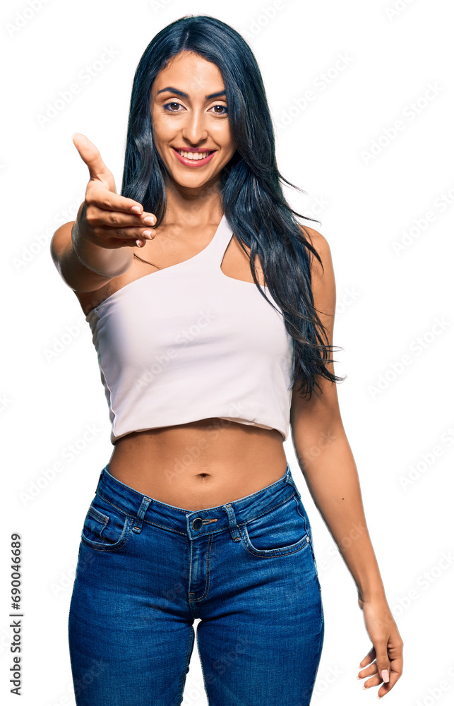 Beautiful hispanic woman wearing casual clothes smiling friendly offering handshake as greeting and welcoming. successful business. Beautiful hispanic woman wearing casual clothes smiling friendly offering handshake as greeting and welcoming. successful business.