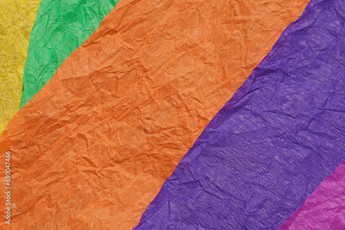 Multicolored background made from pieces of wrinkled decorative paper. Color, saturation, texture. 