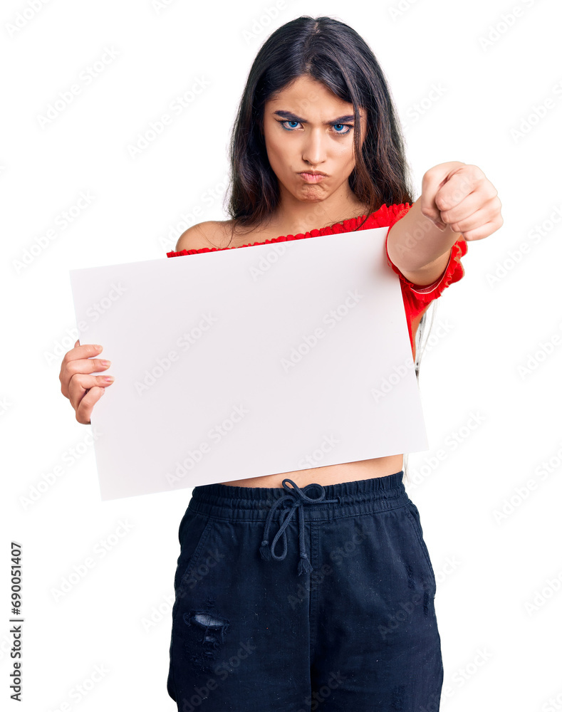 Brunette teenager girl holding blank empty banner annoyed and frustrated shouting with anger, yelling crazy with anger and hand raised Brunette teenager girl holding blank empty banner annoyed and frustrated shouting with anger, yelling crazy with anger and hand raised