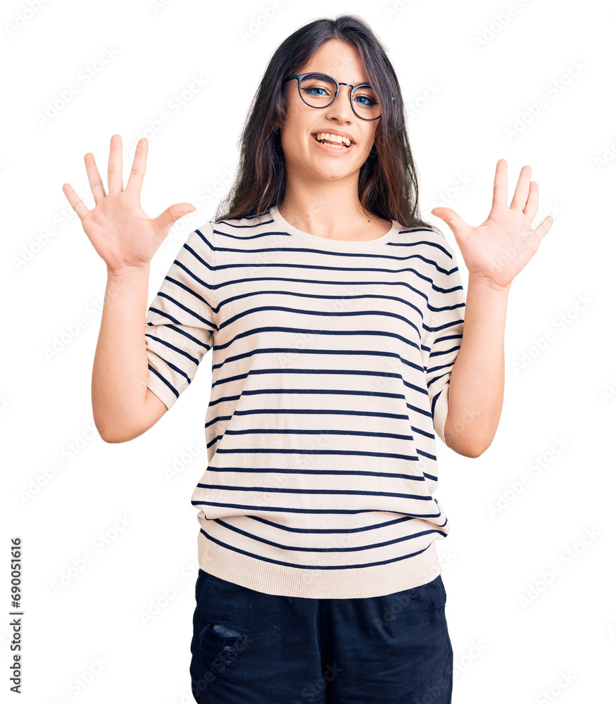 Brunette teenager girl wearing casual clothes and glasses showing and pointing up with fingers number ten while smiling confident and happy. Brunette teenager girl wearing casual clothes and glasses showing and pointing up with fingers number ten while smiling confident and happy.