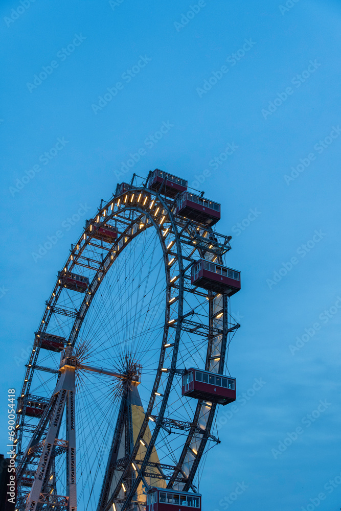 Giant ferris wheel against clear evening sky in Vienna, Austria.