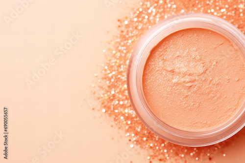 beautiful shiny face blush in color of the year 2024 peach fuzz color flat lay on a pastel peach background