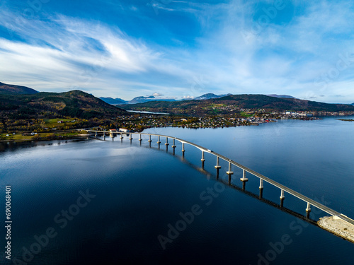 Obraz na płótnie aerial view of Tresfjord Bridge with mountains on background with reflections on water in norway w salonie