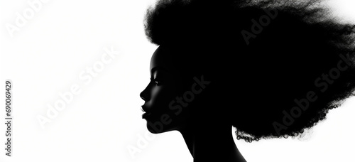 a silhouette of a woman with an afro hair style photo