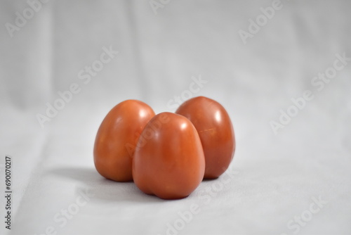 Tomatoes isolated on white background, Three fresh raw vegetables. Full depth of field. Side View 