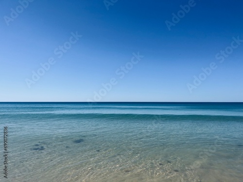 Fototapeta Naklejka Na Ścianę i Meble -  Calm blue ocean horizon, clear blue sky, sea surface background