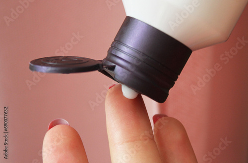 Woman cosmetique cream on finger