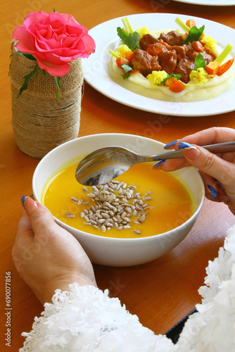 Soup with woman hands and rose