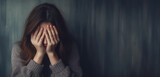 Woman covering face with hands, emotional distress, blurred background
