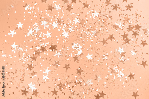 Peach Christmas background with confetti.