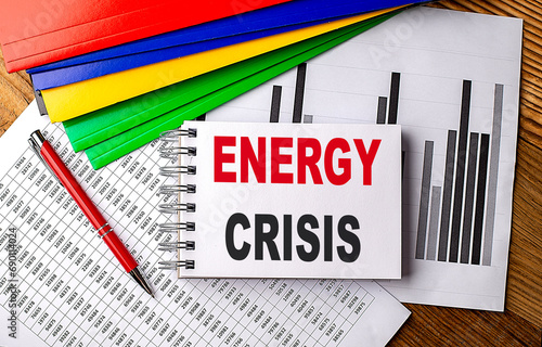 ENERGY CRISIS text on a notebook with pen, folder on a chart background