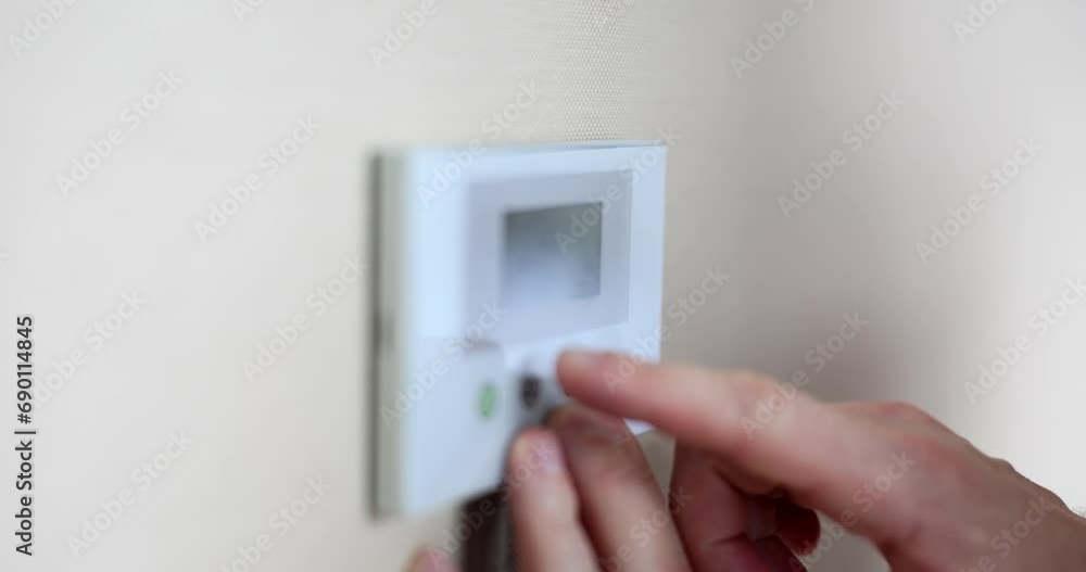 Male hands pressing temperature increase buttons on air conditioner closeup 4k movie slow motion. Comfortable temperature at home concept Male hands pressing temperature increase buttons on air conditioner closeup 4k movie slow motion. Comfortable temperature at home concept