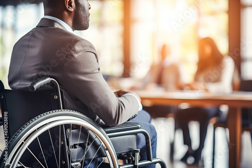 Businessman in wheelchair at a work meeting photo