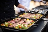 caterer organizing seared tuna steak dishes for an event