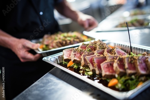 caterer organizing seared tuna steak dishes for an event photo