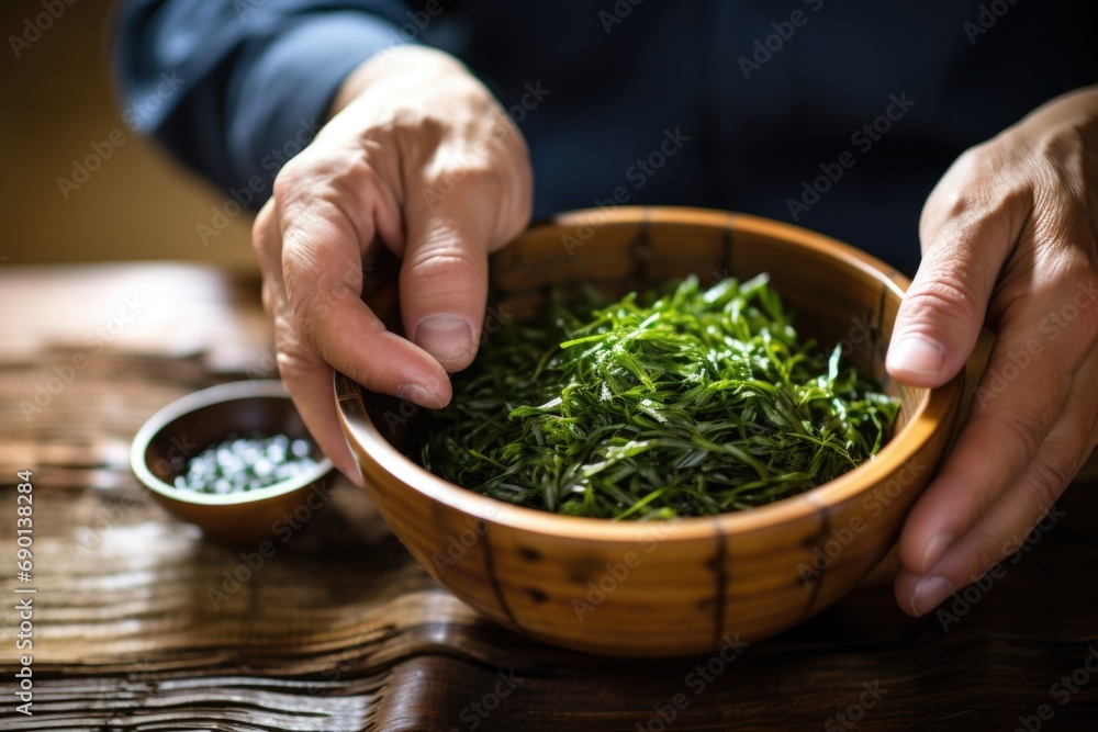 man having seaweed salad in a bamboo bowl man having seaweed salad in a bamboo bowl