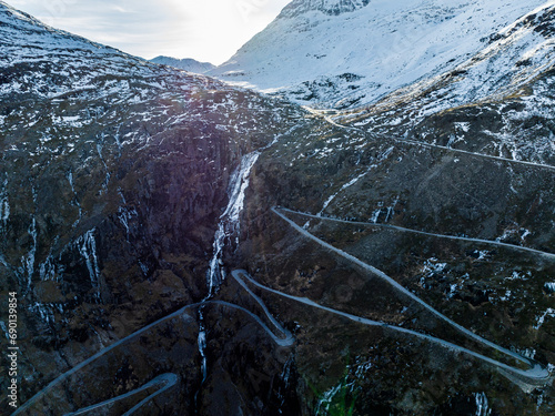 aerial view from drone of winding road trolls ladder trolstigen during winter with snow in mountains photo