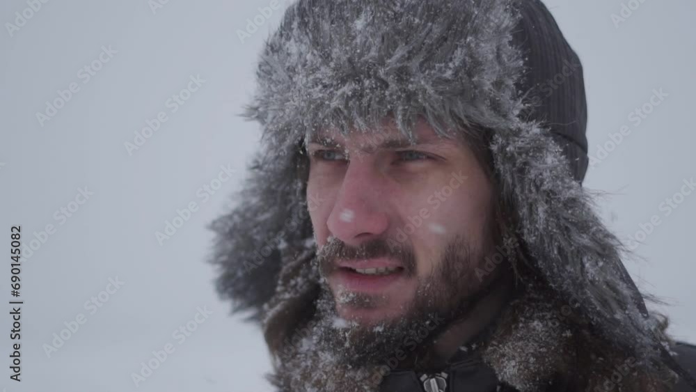 a man in a hat with earflaps in the snow a man in a hat with earflaps in the snow
