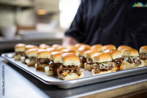 bbq sliders on tray with chef in background