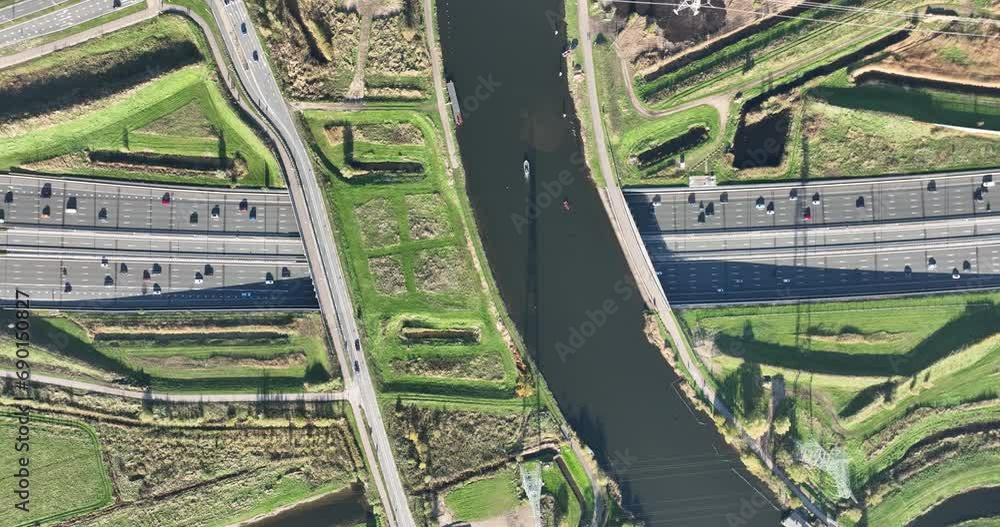 Aerial drone viw of dutch infrastructure highway running under a canal. Near Amsterdam, The Netherlands. Aerial drone viw of dutch infrastructure highway running under a canal. Near Amsterdam, The Netherlands.