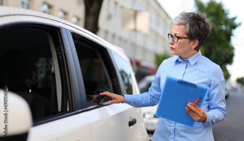 Businesswoman agent inspect document in car, providing insurance assistance, ensuring safety.