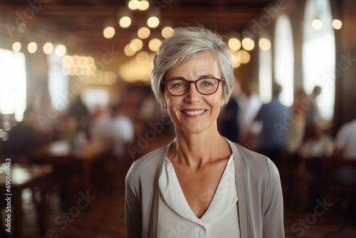 A senior female educator with a knowledgeable smile  realistic HD close-up  in a classic library setting blur